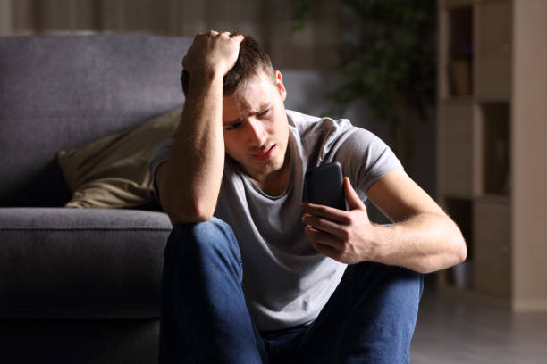 man crying while holding phone